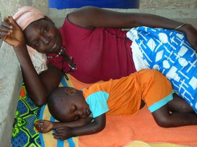 Senegal mother sleeping with child 